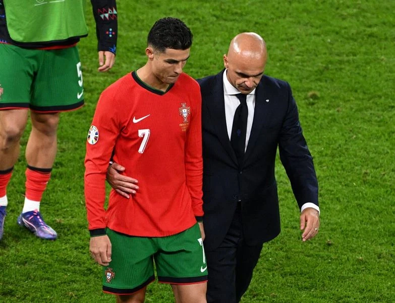 Huấn luyện viên Roberto Martinez an ủi Cristiano Ronaldo sau loạt sút luân lưu. (Ảnh: Reuters)