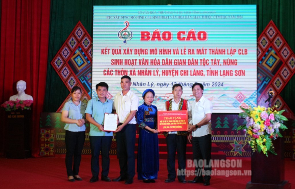 Lãnh đạo UBND huyện Chi Lăng và Trưởng Ban Tổ chức xây dựng mô hình CLB sinh hoạt văn hóa dân gian lần lượt trao quyết định thành lập và biểu trưng hỗ trợ cho Ban Chủ nhiệm CLB