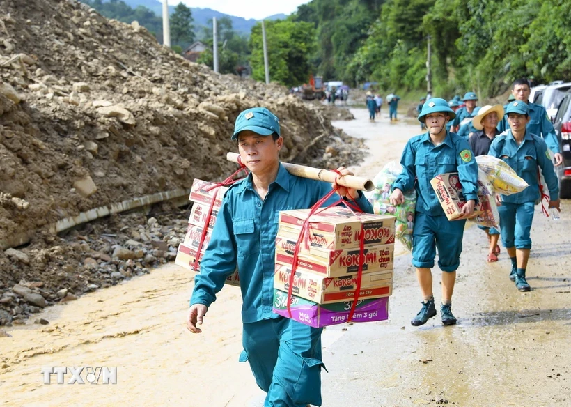 Các lực lượng tham gia vận chuyển đồ cứu trợ cho người dân vùng lũ Điện Biên. (Ảnh: Xuân Tư/TTXVN)