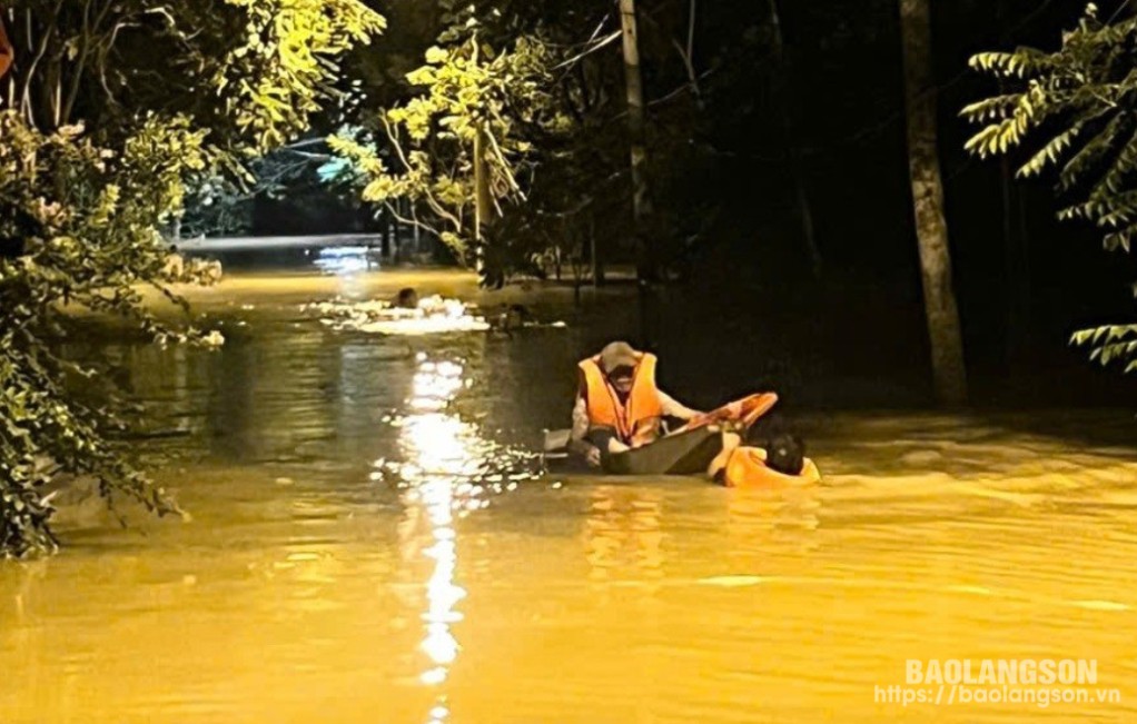 Hình ảnh người dân (trên thuyền tôn) được Thượng úy Dương Hữu Công và Trung úy Chu Văn Liêm đưa từ vùng ngập lụt ra khu vực an toàn