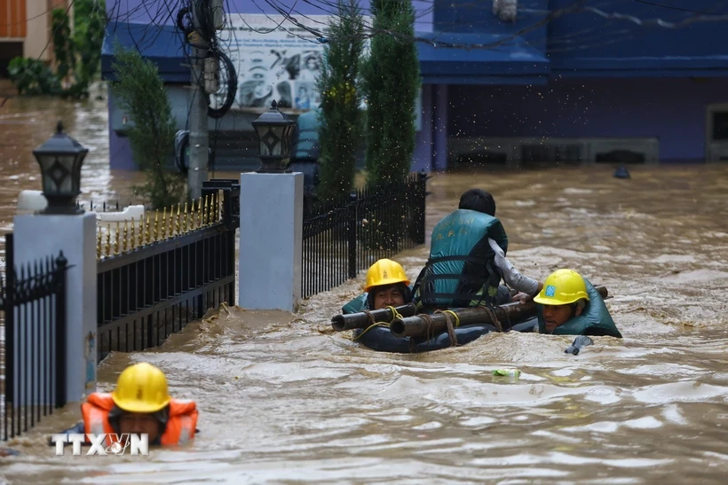 Lực lượng cứu hộ hỗ trợ người dân sơ tán khỏi khu vực ngập lụt tại Lalitpur, Nepal ngày 28/9/2024. (Ảnh: THX/TTXVN)