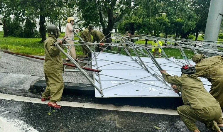 Lực lượng Công an, Bộ đội biên phòng, dân quân địa phương dọn biển quảng cáo và cây xanh ngã đổ do bão số 6.