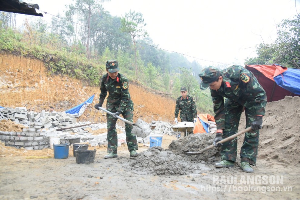 Chiến sĩ Tiểu đoàn 1, Trung đoàn 123 Bộ Chỉ huy Quân sự tỉnh giúp đỡ người dân xã Mẫu Sơn, huyện Lộc Bình chuẩn bị vật liệu xây dựng nhà ở