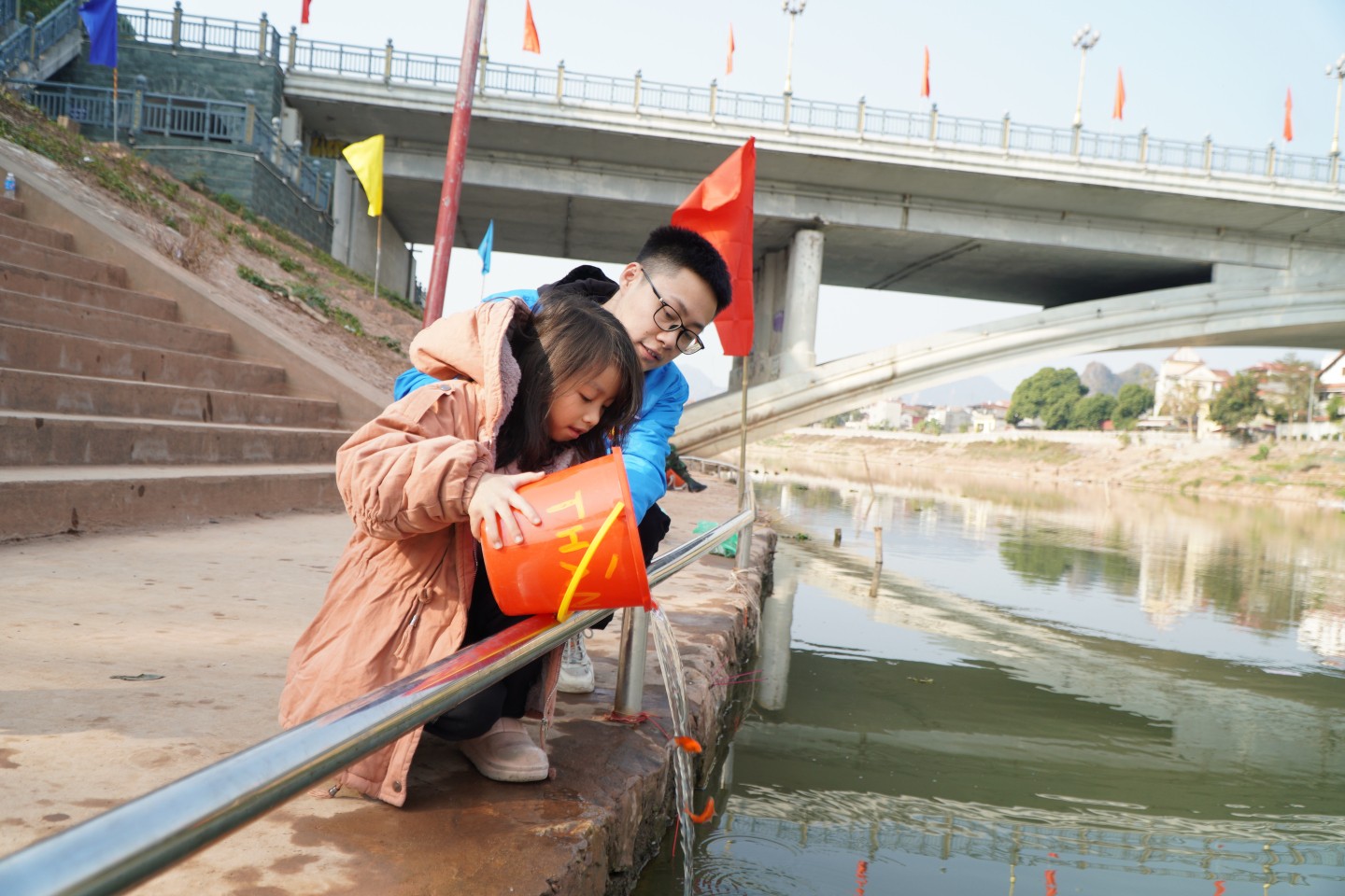 Nhiều gia đình đưa con nhỏ cùng đi thả cá chép tiễn ông Công, ông Táo, kể chuyện và hướng dẫn con trẻ thả cá để giúp các bạn nhỏ hiểu hơn về nét đẹp văn hoá truyền thống.