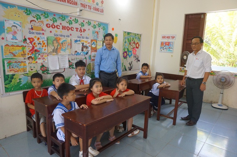 Thầy giáo Phan Văn Tuần (áo trắng) và thầy giáo Trương Hồng Lĩnh (áo xanh) cùng thế hệ tương lai đang trưởng thành từng ngày nơi đảo xa - Ảnh: VGP/Sơn Hào