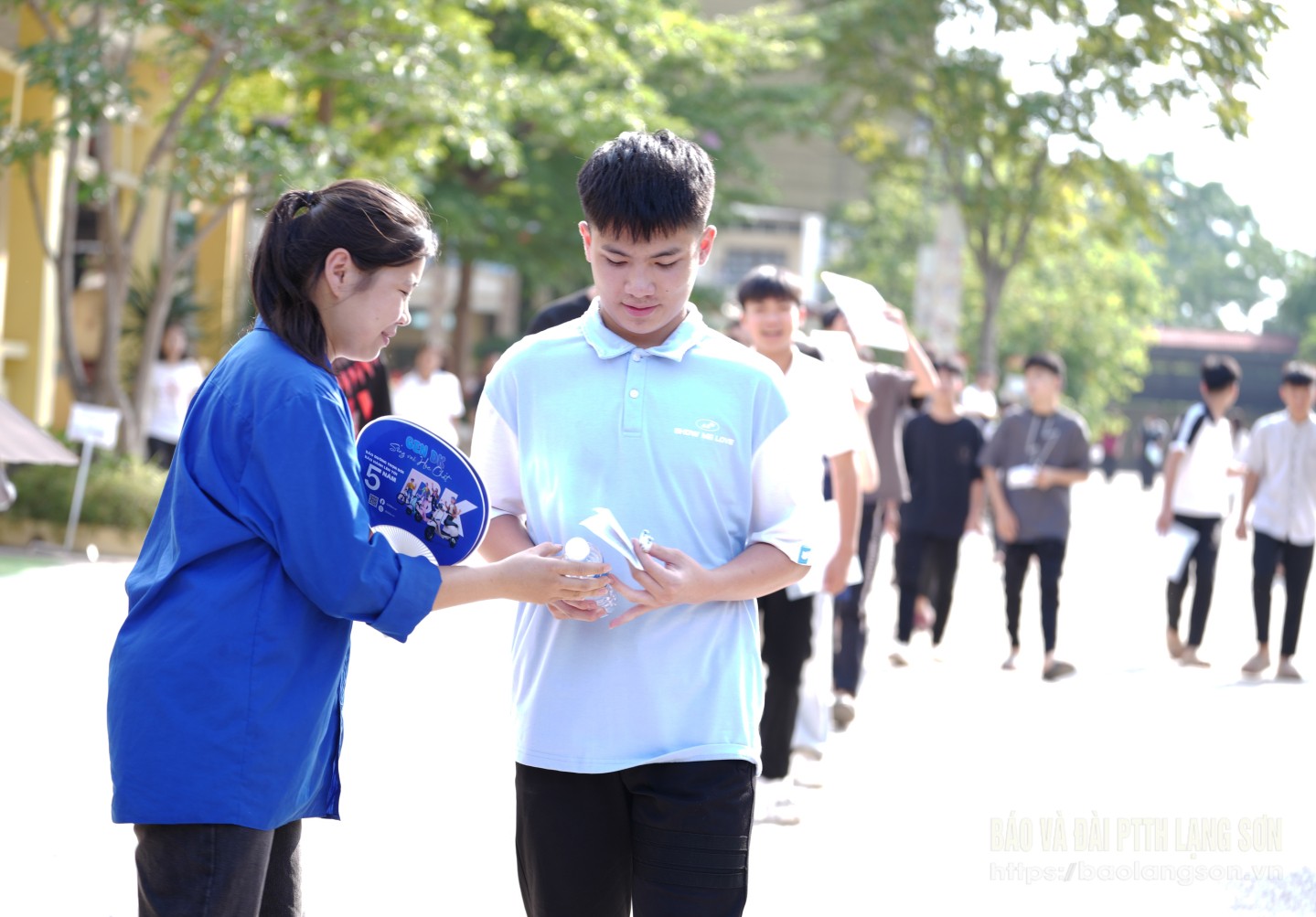 Đoàn viên thanh niên tại điểm Trường THPT Cao Lộc, huyện Cao Lộc đưa nước cho thí sinh sau khi hoàn thành bài thi