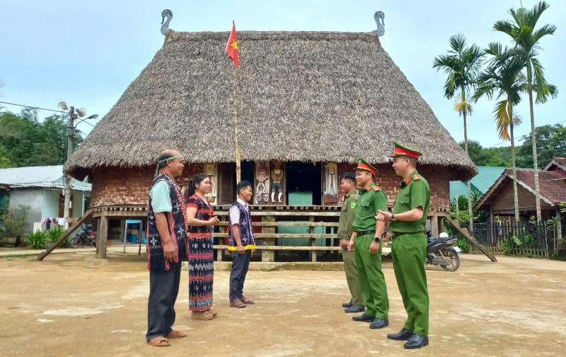 Cán bộ Công an xã Avương thăm hỏi, trò chuyện với già làng, người có uy tín tại địa phương.