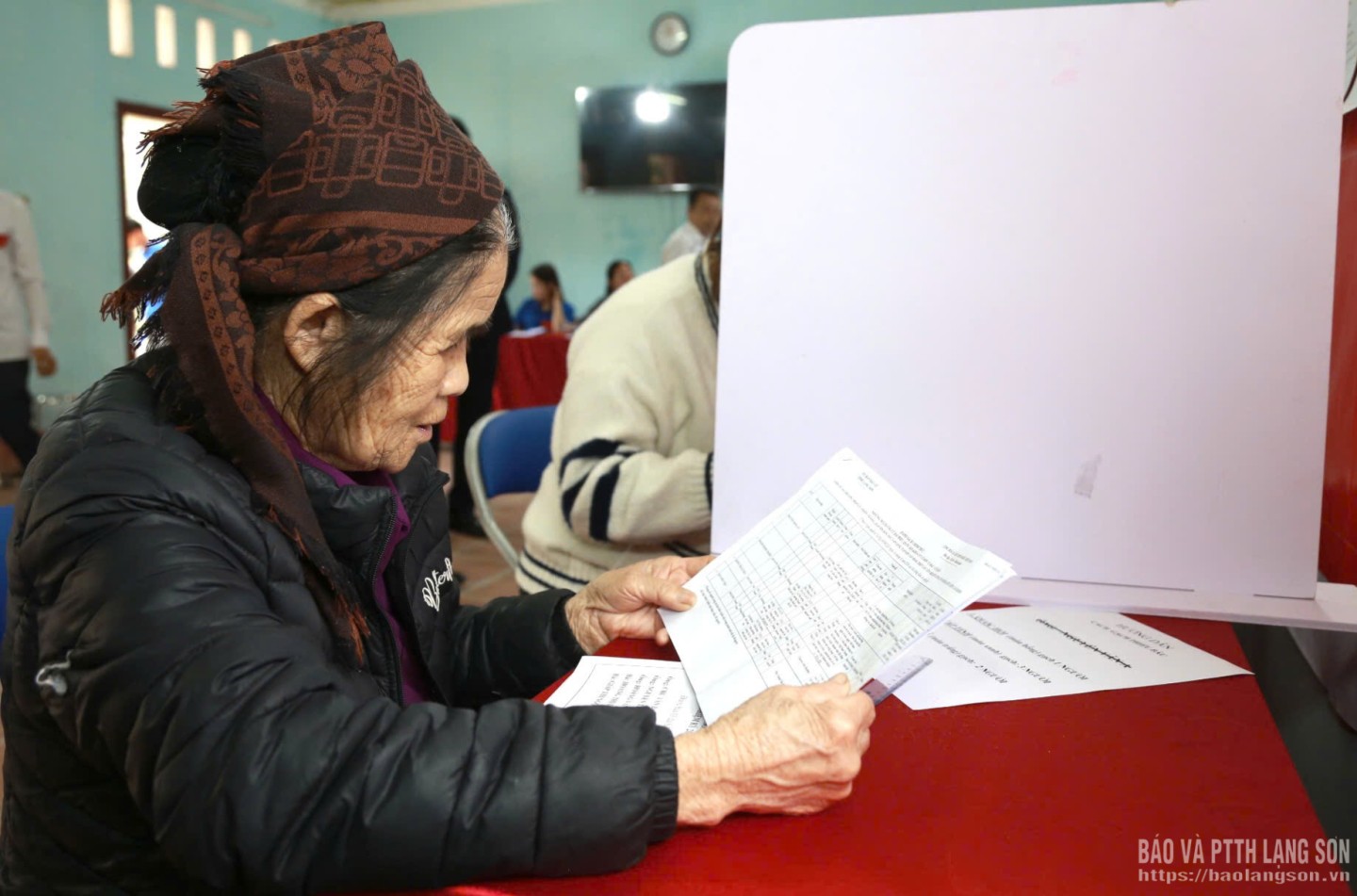 Bà Vy Thị Loan, thôn Làng Hạ, xã Quan Sơn đọc kỹ tiểu sử các ứng cử viên trước khi bỏ phiếu bầu